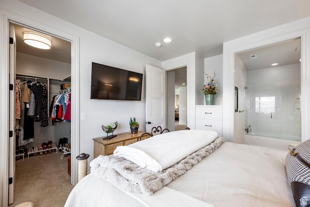 bedroom featuring a walk in closet, a closet, carpet, and connected bathroom