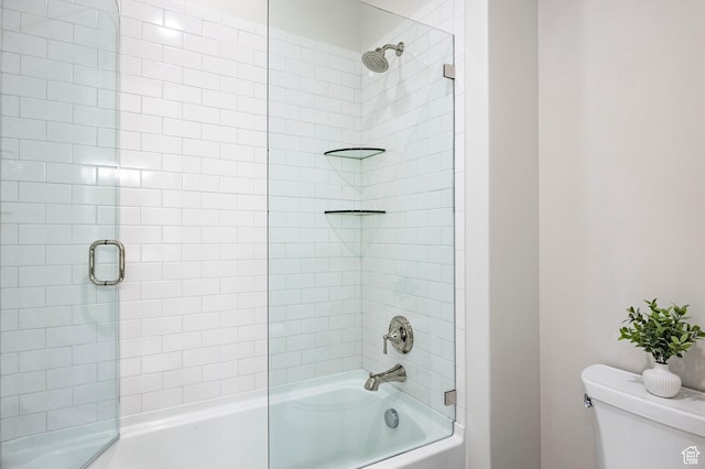 bathroom with toilet and enclosed tub / shower combo