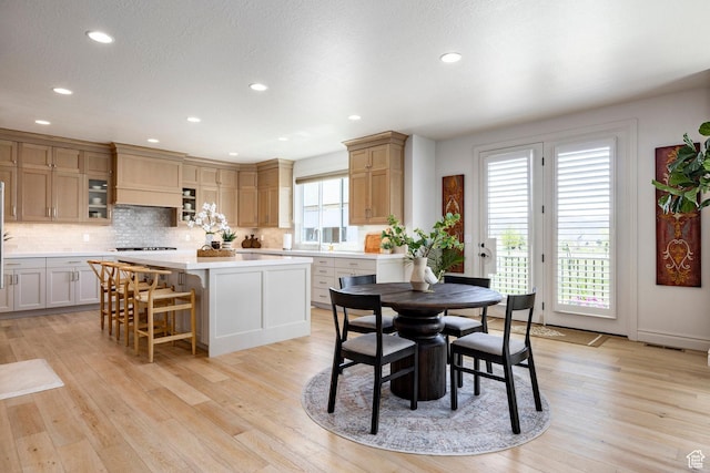 dining space with recessed lighting and light wood-style flooring