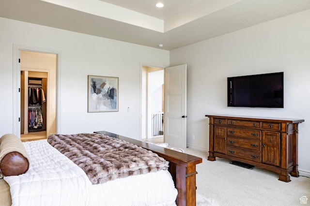 bedroom with light carpet, recessed lighting, and baseboards
