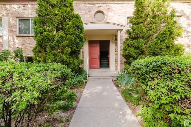 view of exterior entry with brick siding