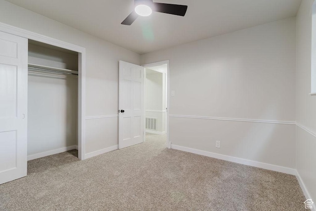 unfurnished bedroom featuring baseboards, visible vents, and carpet