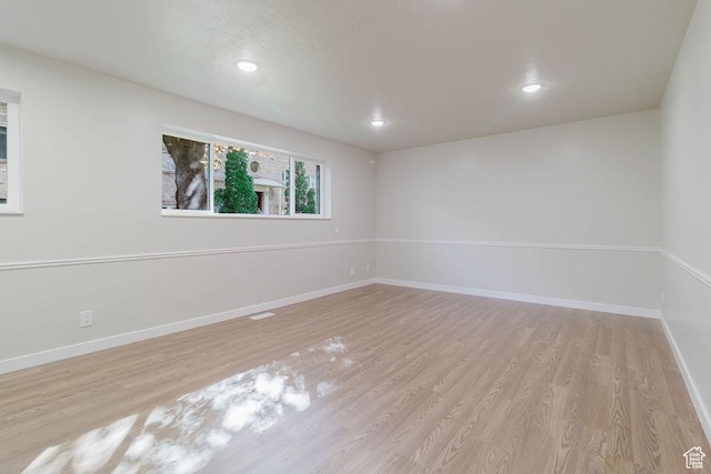 unfurnished room featuring baseboards, recessed lighting, and wood finished floors