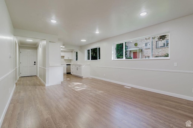 unfurnished living room with light wood-style floors, visible vents, baseboards, and recessed lighting