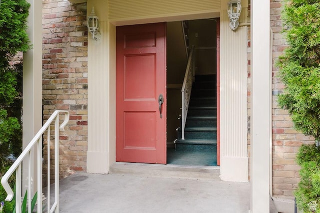 view of exterior entry featuring brick siding