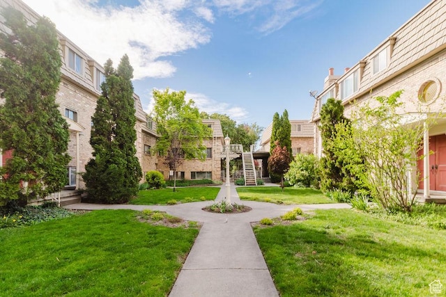 view of property's community with a lawn