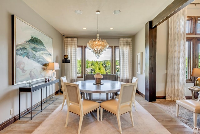 dining room featuring recessed lighting, light wood-type flooring, baseboards, and a notable chandelier