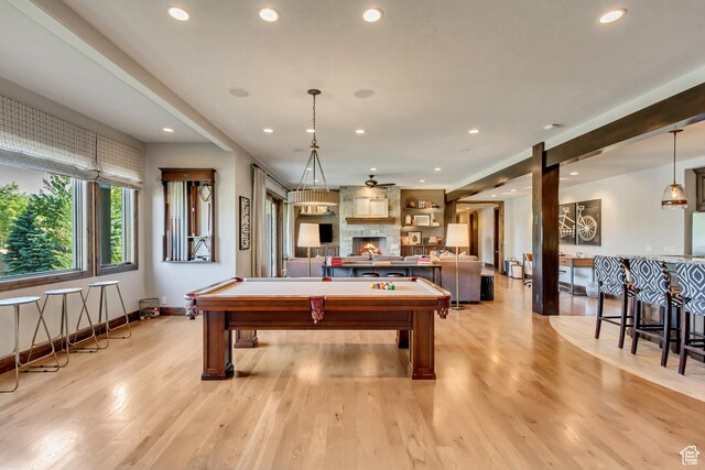 playroom featuring light wood finished floors, pool table, baseboards, a large fireplace, and recessed lighting