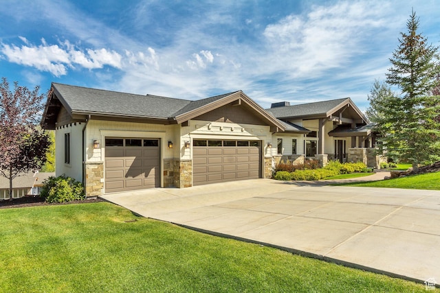 craftsman-style home with concrete driveway, stone siding, a front lawn, and an attached garage