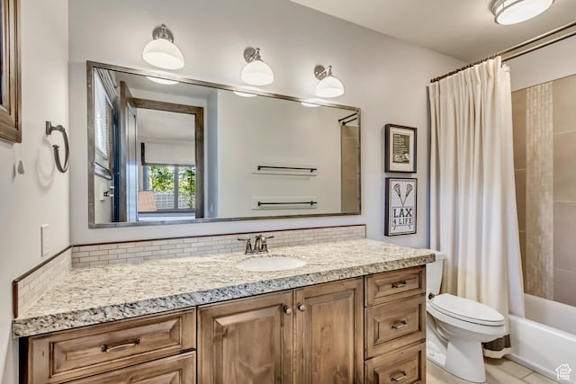 full bath with vanity, tasteful backsplash, toilet, and shower / bath combo
