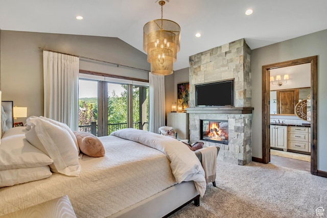 carpeted bedroom with lofted ceiling, recessed lighting, connected bathroom, a tiled fireplace, and access to exterior