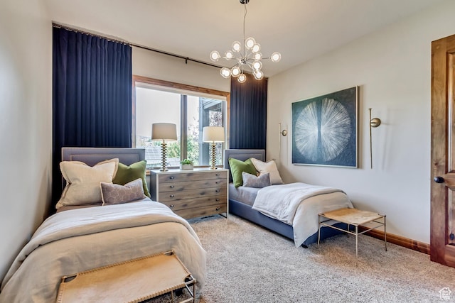bedroom featuring baseboards, an inviting chandelier, and carpet floors