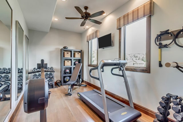 exercise room with baseboards, wood finished floors, a ceiling fan, and recessed lighting