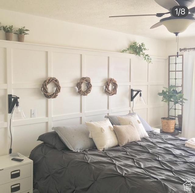 bedroom featuring a decorative wall and a ceiling fan