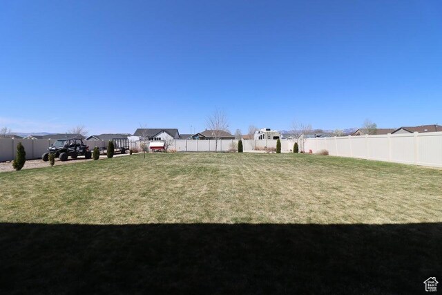 view of yard featuring a residential view and a fenced backyard