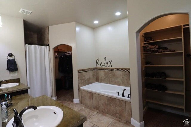bathroom featuring visible vents, recessed lighting, tile patterned flooring, a spacious closet, and a bath