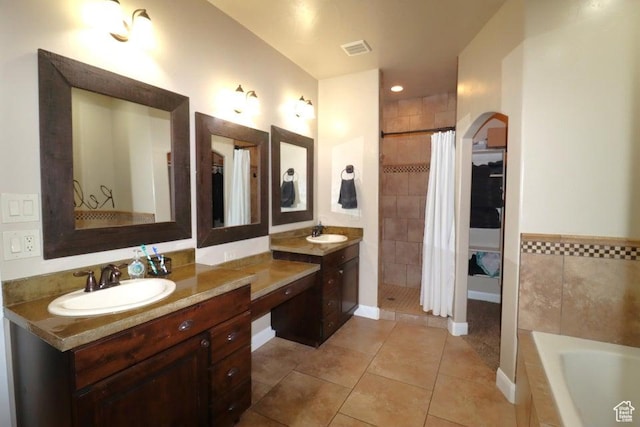 bathroom with vanity, visible vents, tile patterned floors, a garden tub, and tiled shower
