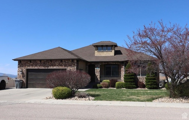 view of front of house with stone siding, concrete driveway, a garage, and a front lawn