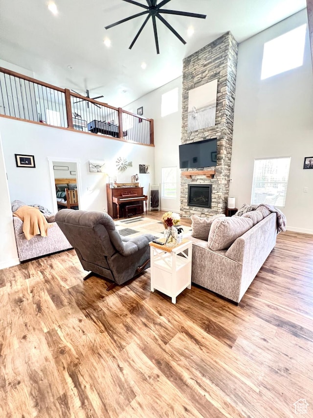 954 N 280 E, Elsinore, UT 84724 - living area featuring a fireplace, high vaulted ceiling, a ceiling fan, and wood finished floors