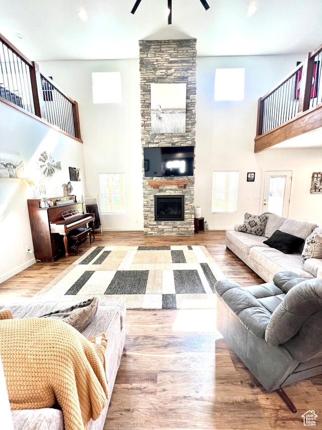 954 N 280 E, Elsinore, UT 84724 - living area featuring a stone fireplace, a towering ceiling, a ceiling fan, and wood finished floors