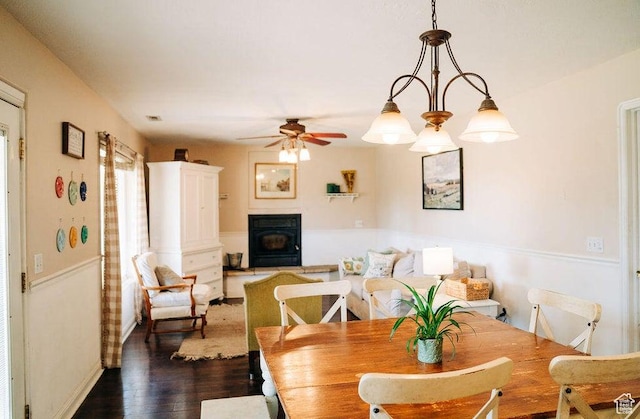 1478 S 4200 W, Cedar City, UT 84720 - dining room featuring a wood stove, dark wood-type flooring, baseboards, and ceiling fan