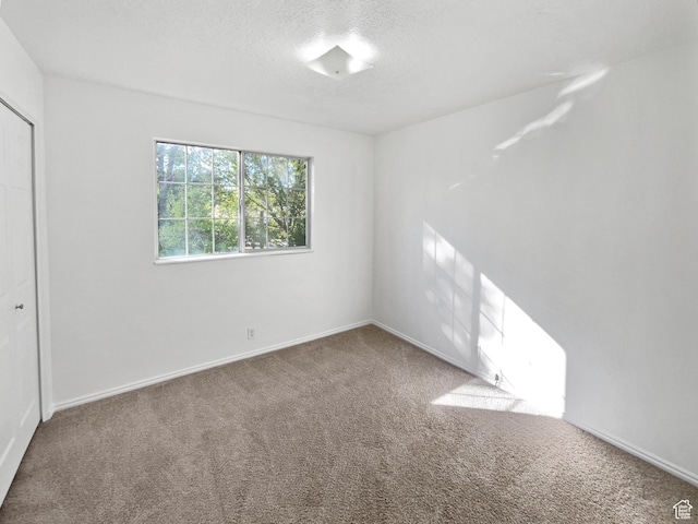 1303 N Riverside Ave Unit 32, Provo, UT 84604 - spare room featuring carpet, a textured ceiling, and baseboards