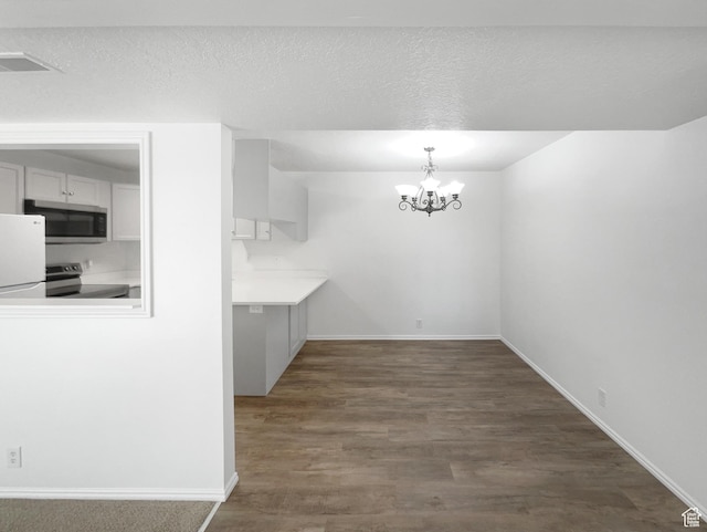 1303 N Riverside Ave Unit 32, Provo, UT 84604 - unfurnished dining area featuring baseboards, a textured ceiling, a chandelier, and dark wood-style floors