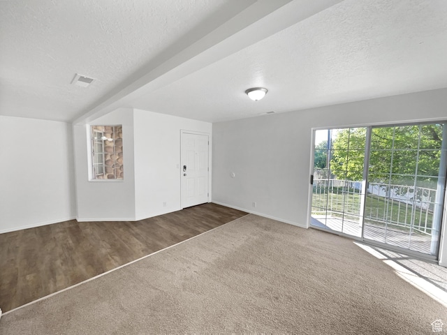 1303 N Riverside Ave Unit 32, Provo, UT 84604 - unfurnished living room featuring baseboards, carpet, a textured ceiling, and wood finished floors