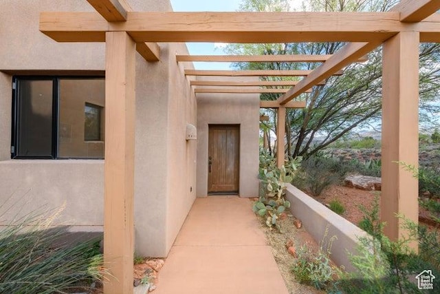 1151 W Shawnee Ct, Ivins, UT 84738 - view of exterior entry featuring stucco siding and a pergola