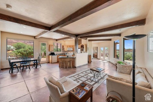 1151 W Shawnee Ct, Ivins, UT 84738 - living room with beamed ceiling, baseboards, light tile patterned floors, and a healthy amount of sunlight
