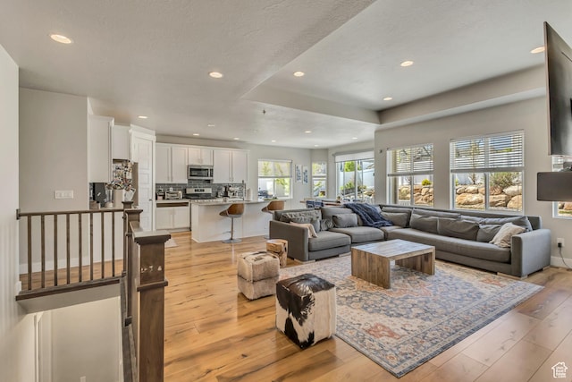 7518 S 5720 W, West Jordan, UT 84081 - living room with light wood-style floors, recessed lighting, and a textured ceiling