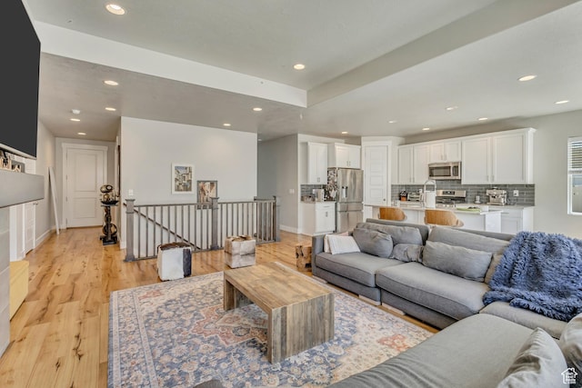 7518 S 5720 W, West Jordan, UT 84081 - living area featuring baseboards, light wood finished floors, and recessed lighting