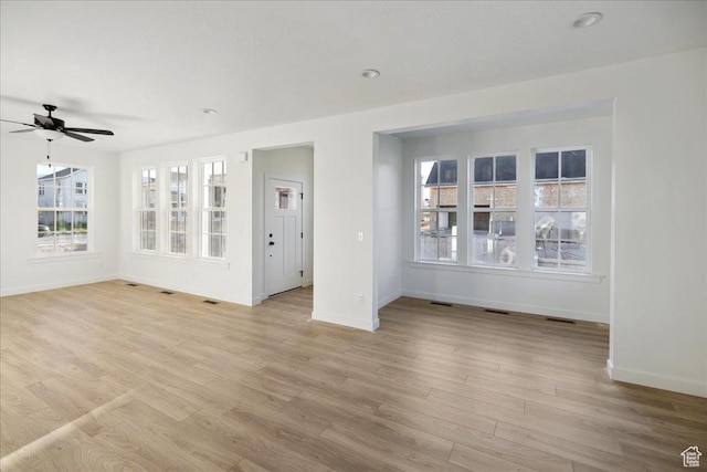 6768 W Docksider Dr Unit 298, South Jordan, UT 84009 - empty room featuring baseboards, healthy amount of natural light, ceiling fan, and light wood finished floors