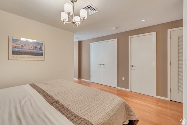 35 E 100 S Unit 204, Salt Lake City, UT 84111 - bedroom featuring baseboards, light wood-style floors, a chandelier, and visible vents