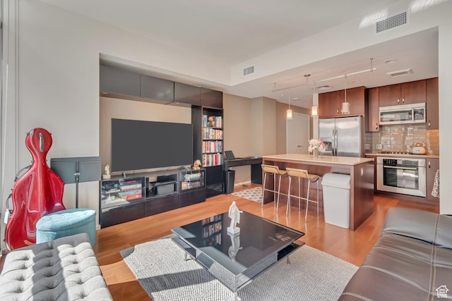 35 E 100 S Unit 204, Salt Lake City, UT 84111 - living area with light wood-style flooring and visible vents