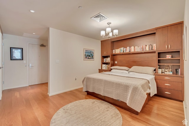 35 E 100 S Unit 204, Salt Lake City, UT 84111 - bedroom with an inviting chandelier, visible vents, light wood-style flooring, and baseboards