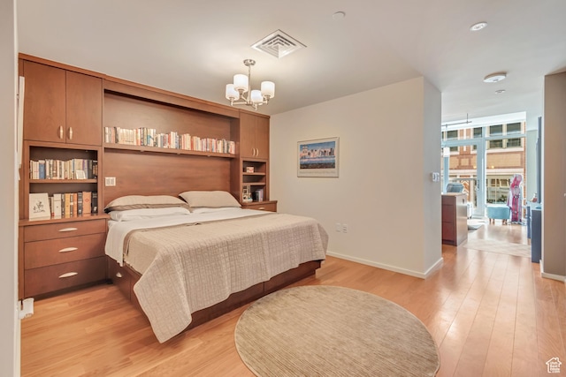 35 E 100 S Unit 204, Salt Lake City, UT 84111 - bedroom featuring an inviting chandelier, light wood-style flooring, baseboards, and visible vents