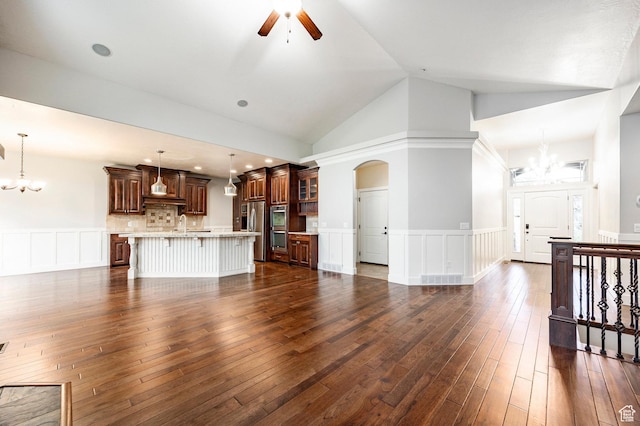 3440 Greenfield Cir, Mountain Green, UT 84050 - unfurnished living room featuring wainscoting, ceiling fan with notable chandelier, arched walkways, and a decorative wall