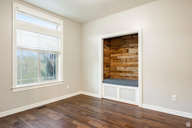 3440 Greenfield Cir, Mountain Green, UT 84050 - empty room featuring baseboards, visible vents, and dark wood-type flooring