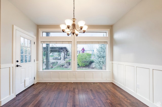 3440 Greenfield Cir, Mountain Green, UT 84050 - unfurnished dining area featuring a decorative wall, a wainscoted wall, dark wood-type flooring, visible vents, and a notable chandelier