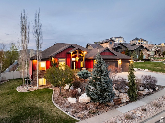 3440 Greenfield Cir, Mountain Green, UT 84050 - craftsman house featuring fence, an attached garage, stone siding, a front lawn, and board and batten siding