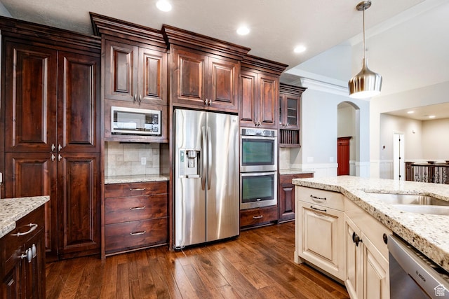 3440 Greenfield Cir, Mountain Green, UT 84050 - kitchen featuring hanging light fixtures, stainless steel appliances, dark wood-type flooring, tasteful backsplash, and light stone counters