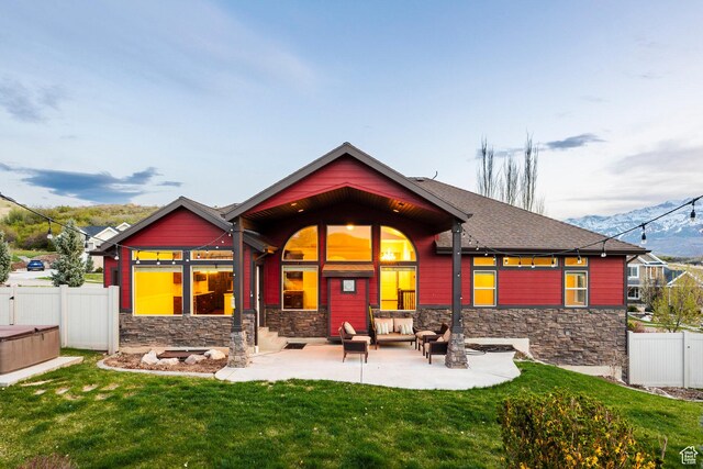 3440 Greenfield Cir, Mountain Green, UT 84050 - rear view of property with a yard, a patio area, fence, and stone siding