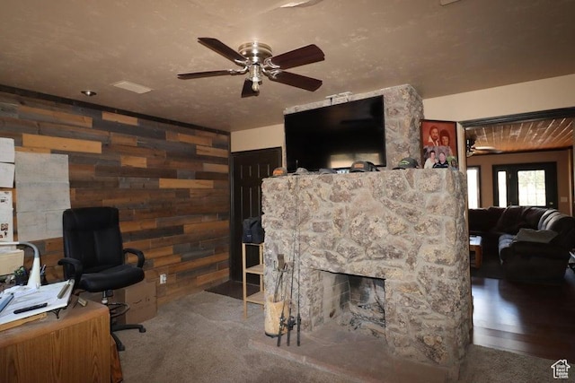 2304 S 11900 W, Cedar City, UT 84720 - living room featuring wooden walls, a fireplace, ceiling fan, and carpet floors