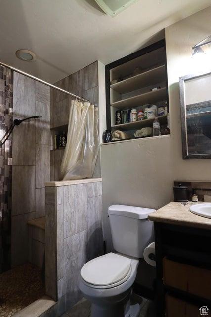 2304 S 11900 W, Cedar City, UT 84720 - bathroom with vanity, toilet, tile walls, and a tile shower