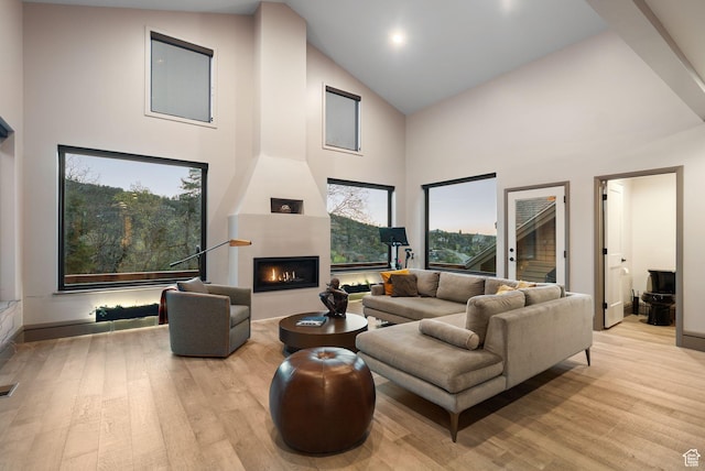 7515 Stagecoach Dr, Park City, UT 84098 - living area with high vaulted ceiling, light wood finished floors, and a fireplace