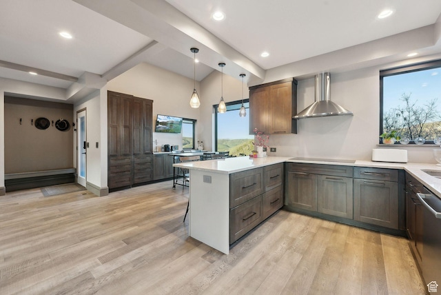 7515 Stagecoach Dr, Park City, UT 84098 - kitchen featuring wall chimney range hood, a peninsula, light wood-type flooring, light countertops, and recessed lighting