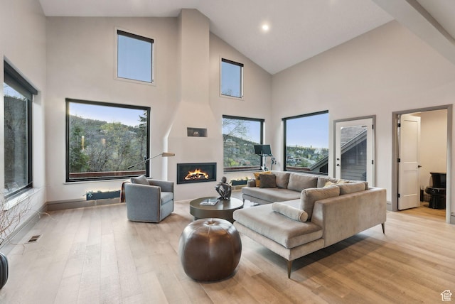 7515 Stagecoach Dr, Park City, UT 84098 - living area with high vaulted ceiling, a large fireplace, light wood-style flooring, and recessed lighting