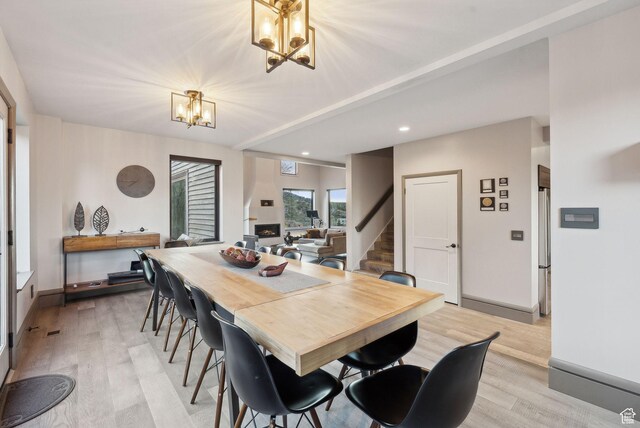 7515 Stagecoach Dr, Park City, UT 84098 - dining space featuring a chandelier, stairs, light wood finished floors, recessed lighting, and a fireplace