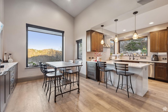 7515 Stagecoach Dr, Park City, UT 84098 - kitchen with dishwasher, light wood finished floors, a kitchen bar, a peninsula, and wall chimney exhaust hood